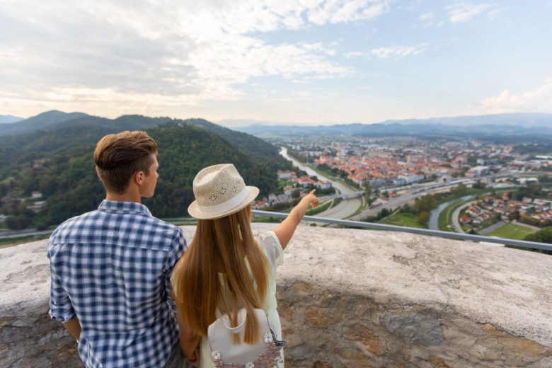 Young couple enjoys the view over Celje from the Old Castle Drazen Stader Produkcija Studio slovenia.info