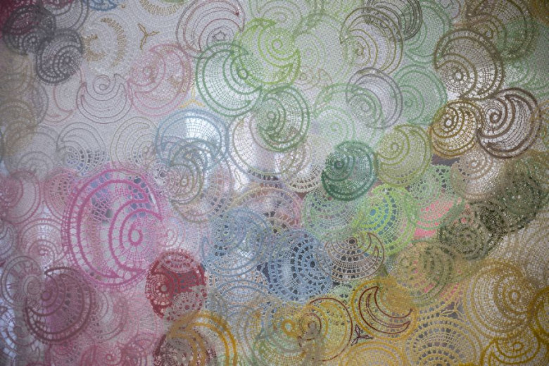 A colorful display of Idrian lace crafted in circular patterns. 