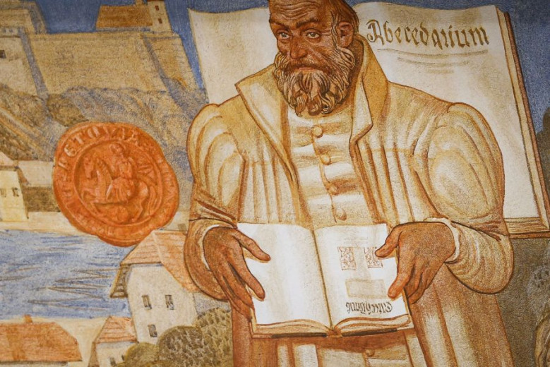 A picture of Primož Trubar holding the Catechism.