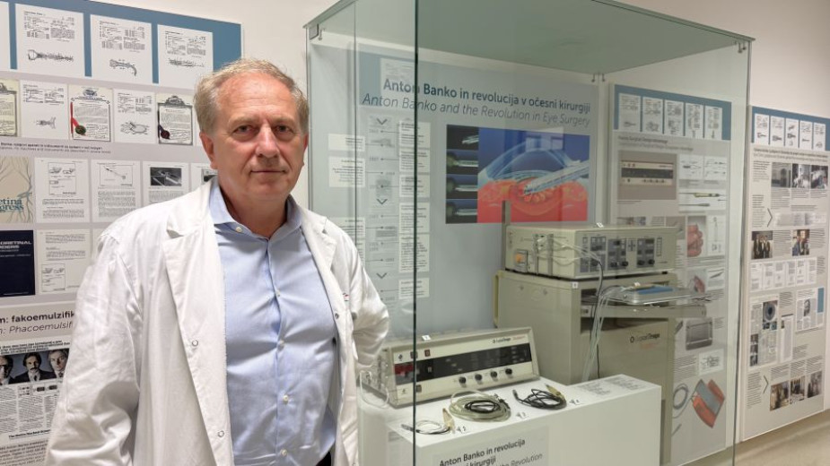 Professor Marko Hawlina stands beside the display case exhibiting the cataract surgery device developed by Slovenian engineer Anton Banko.