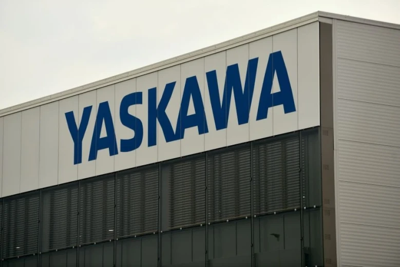 A blue inscription YASKAWA on a building.