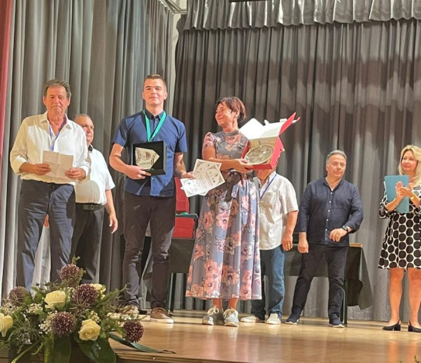 A boy on the podium with the award