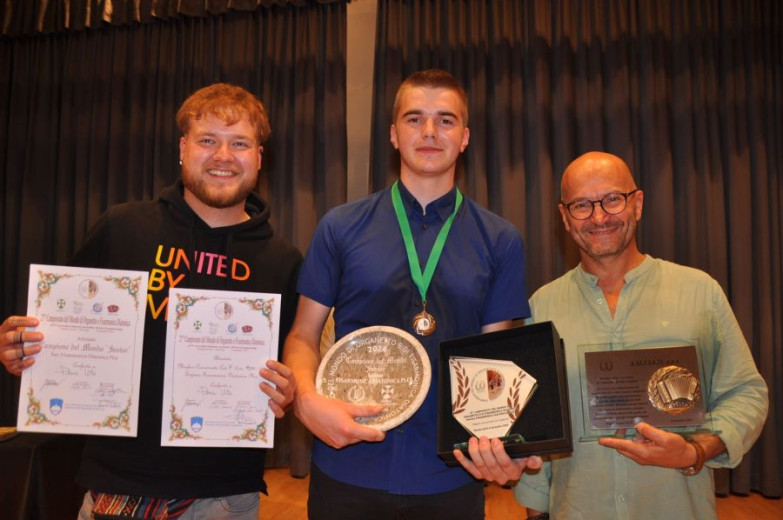 Three men with awards and accolades.