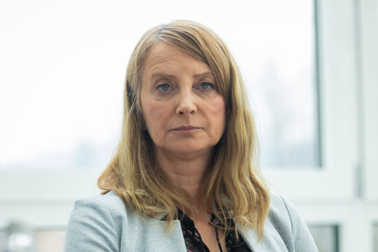 Close-up portrait of Andreja Gomboc, with long, blonde hair, wearing a grey blazer.