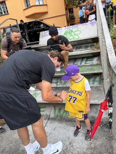 Luka Dončić signs a young fan’s Los Angeles Lakers jersey.