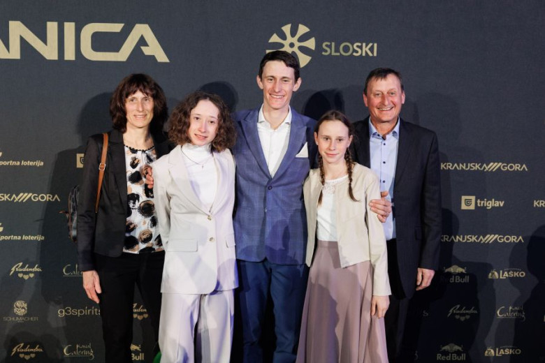 The Prevc family poses for a photo. Peter stands in the middle, with his two younger sisters and both parents beside him.