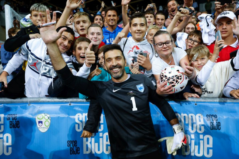 Gianluigi Buffon waves. The audience in the background.