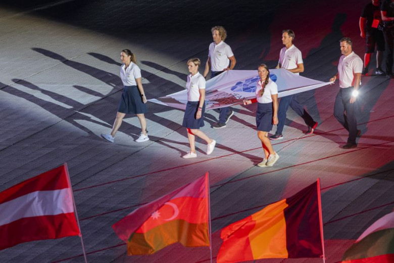 Athletes carry the flag.