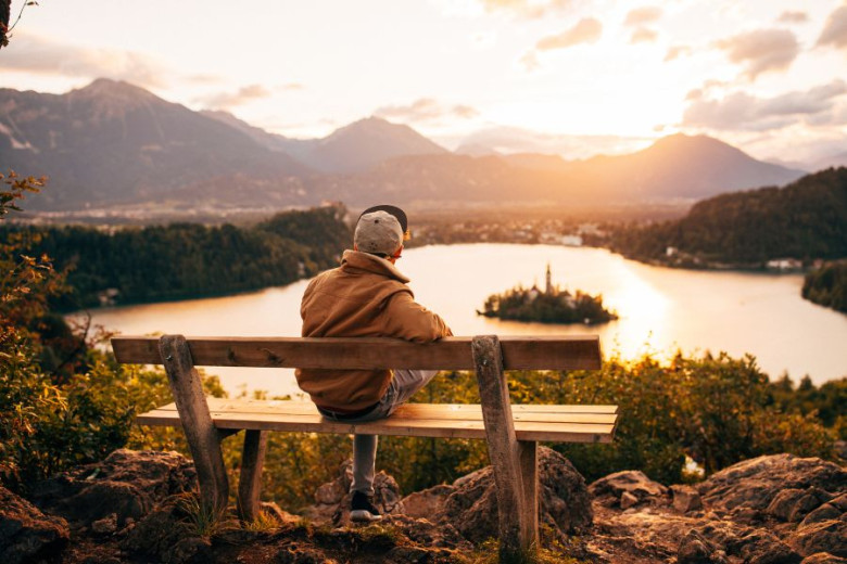 A man is looking at the lake with island