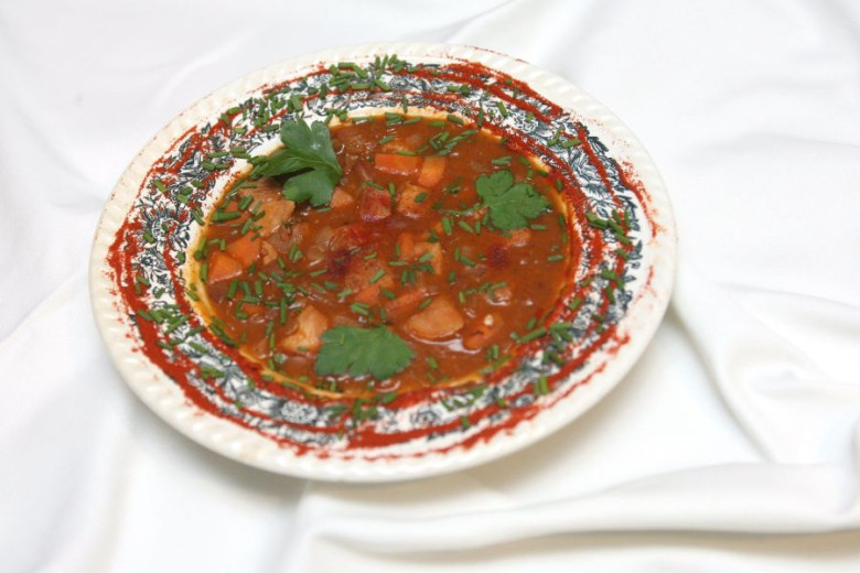 A  plate of the soup with beans and bread on the table