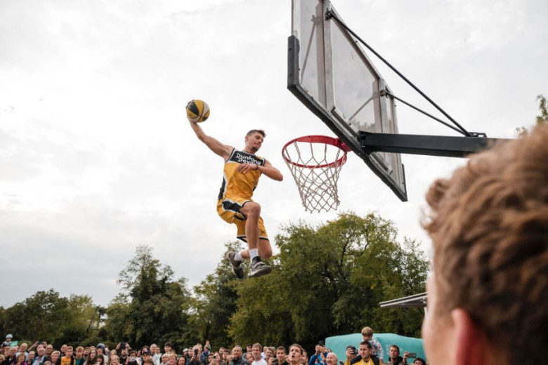 A male acrobat is jumping.