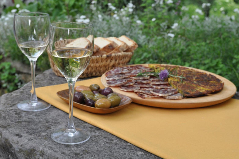 herb and egg omelette and salami and wine on the table