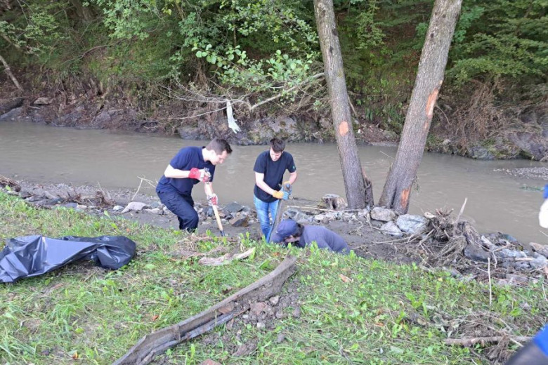 Volunteers cleaning a river bank.