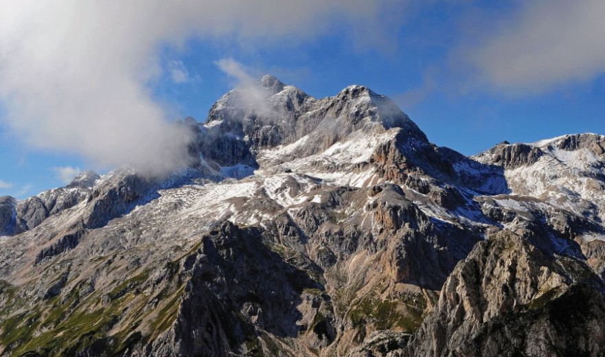 A high mountain and a snow on the top of it