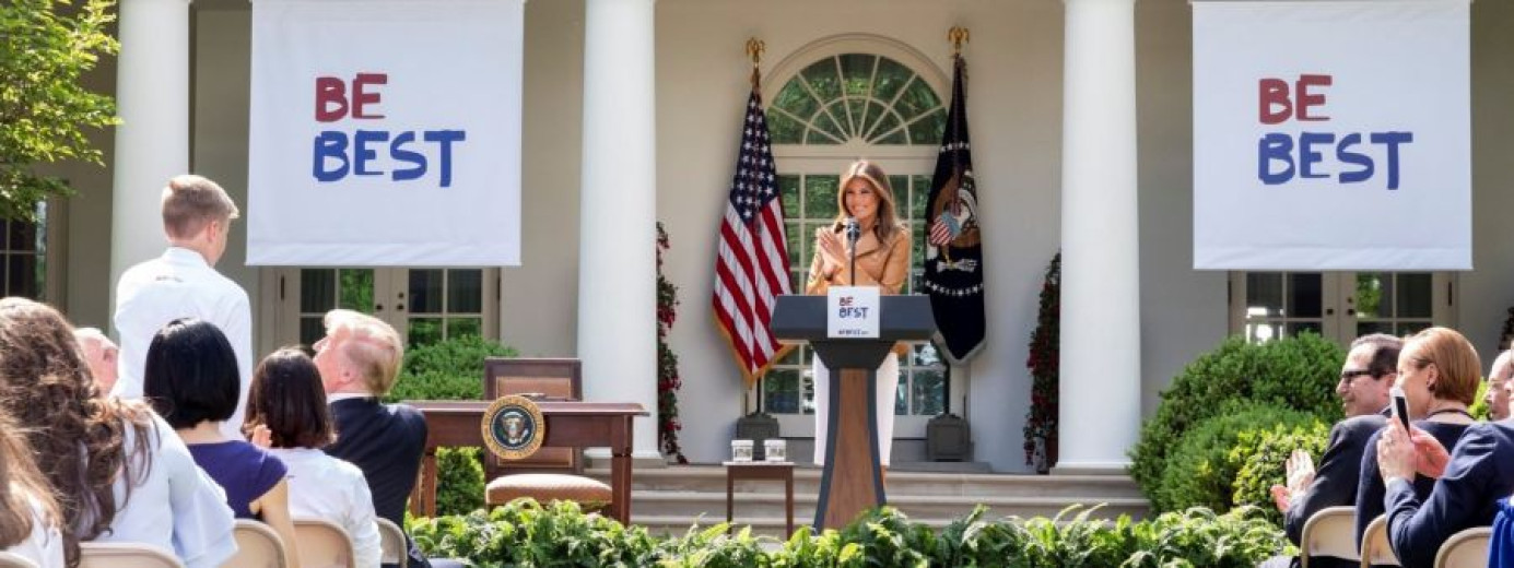 A woman is standing on stage, giving a speech