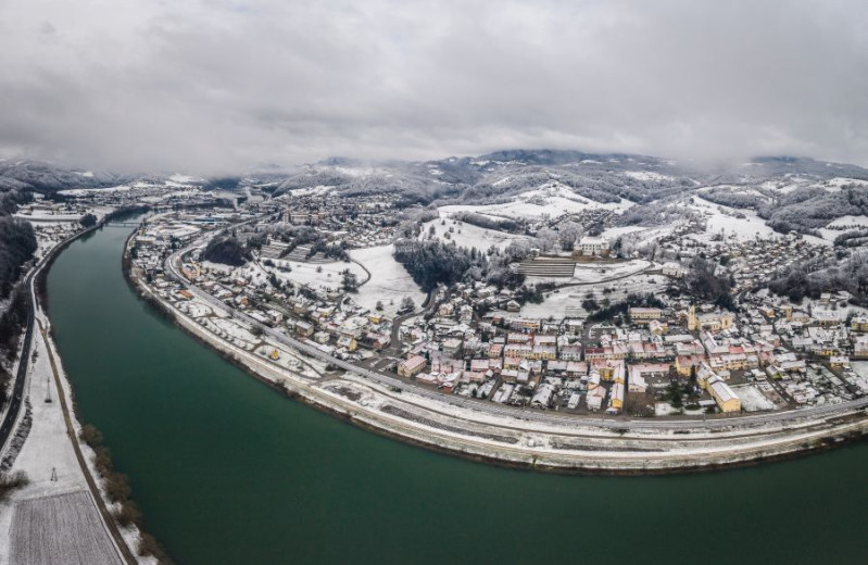 A town by the river in winter with a lot of snow