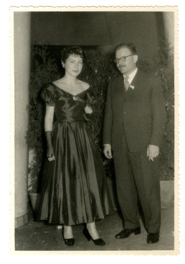 A woman and a man at the dance in the elegant dresses