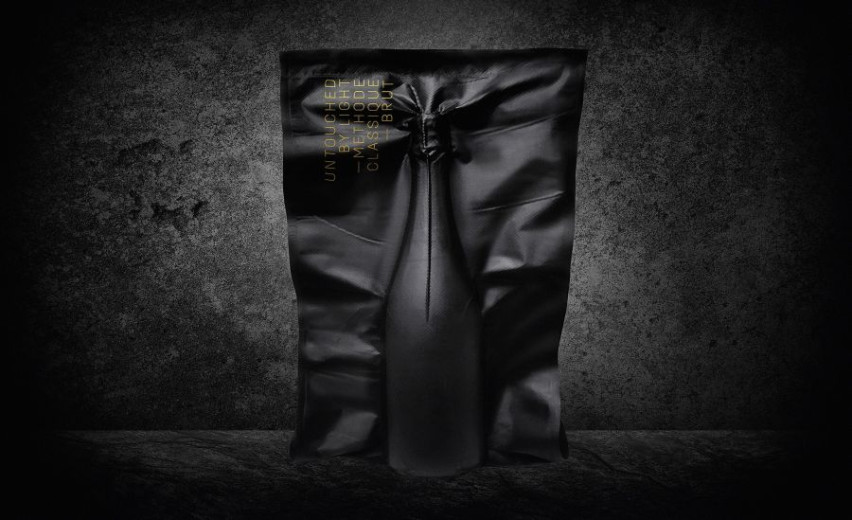 A bottle in a tightly sealed black bag