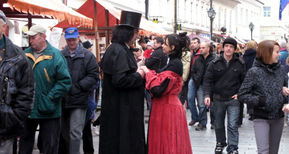 a man with the dark coat and woman in red clothes