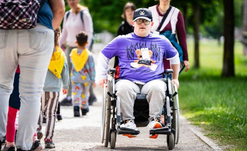 A boy on the wheelchair enjoying in nature