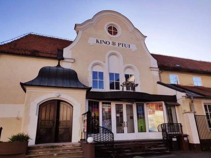 Historic cinema building with an ornate façade and arched windows welcoming visitors.