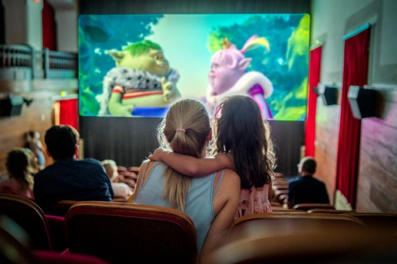 A mother and child share a warm moment while watching an animated film inside one of the world’s oldest cinemas.