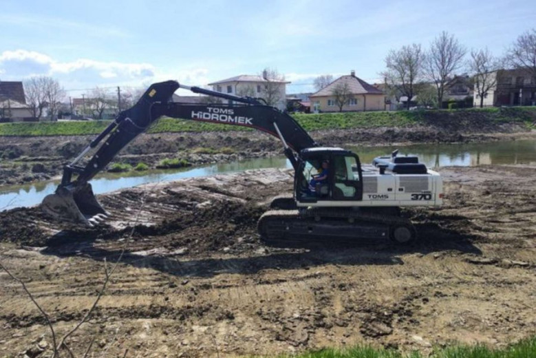 Excavator by the river.