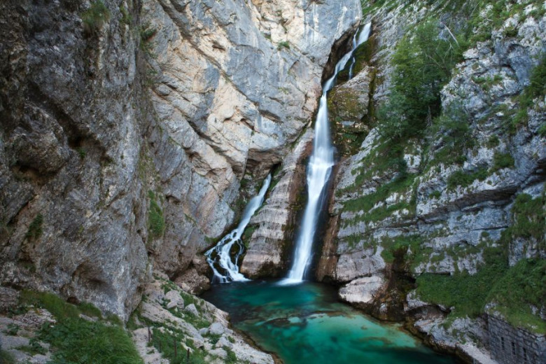 A big waterfall in the mountains and in the forest