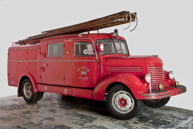 A big and red firefighter old - timer car.