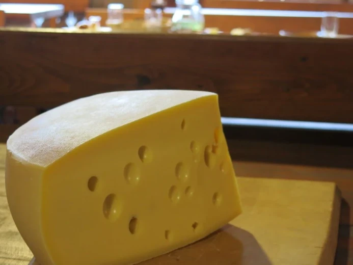 A big piece of cheese with holes in it. 