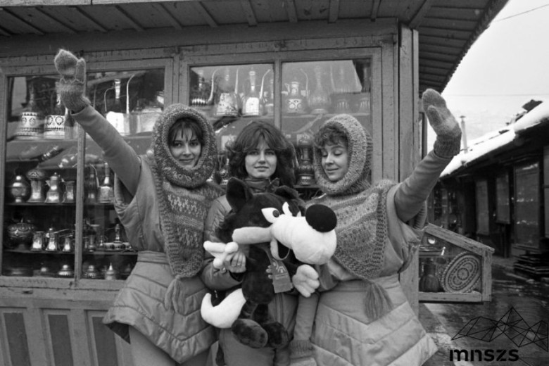Women holding a mascot of the olympic games in Sarajevo. 