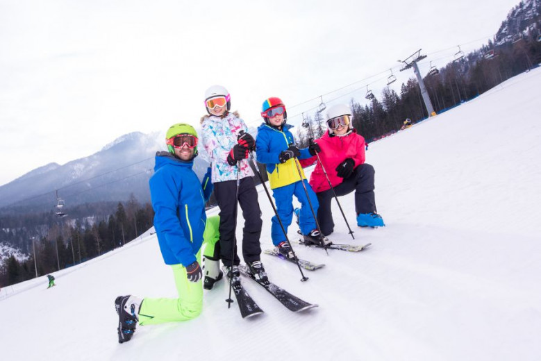 Skier and children on the ski slope.