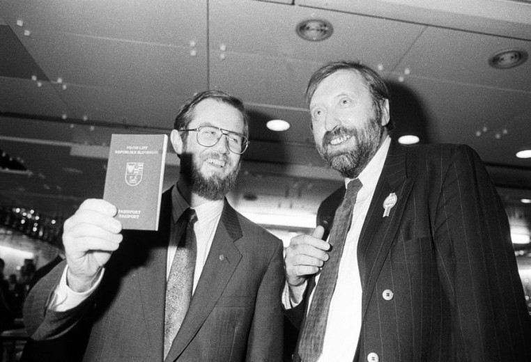 Lojze Peterle holding a passport and Dimitrij Rupel.