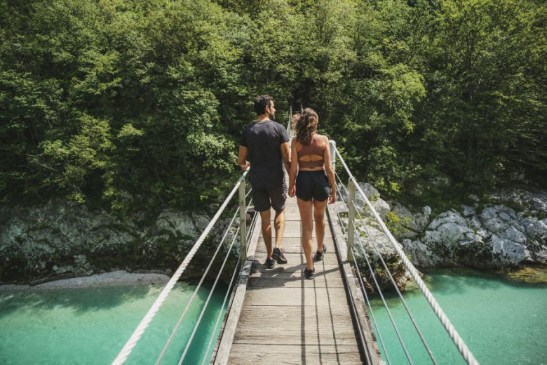 Couple crossing the brigde over Soča river