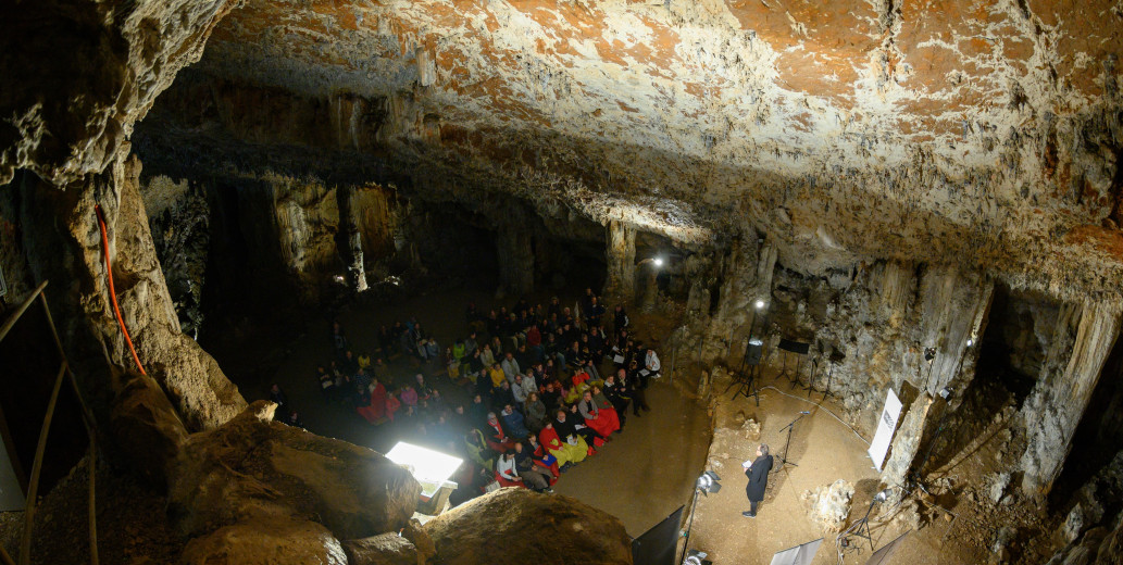 People are sitting in the cave and reading books