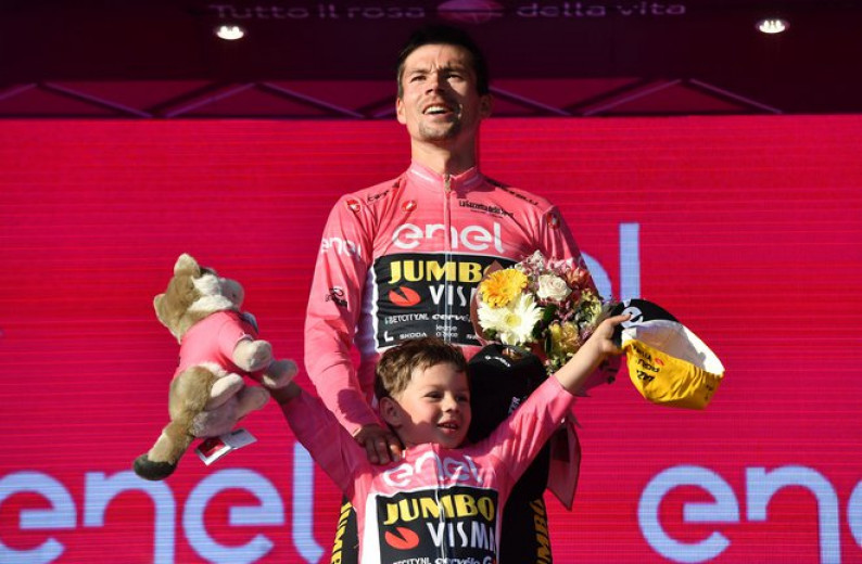 Roglič with his son Leo on the winner's podium.