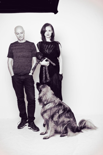 Tomaž and Urška Draž are standing with a dog sitting next to them.