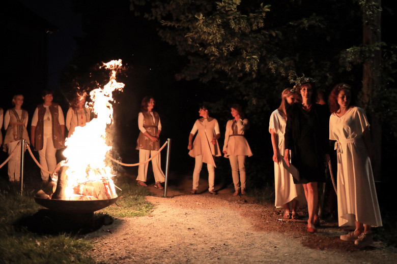 Participants form a circle around the fire.