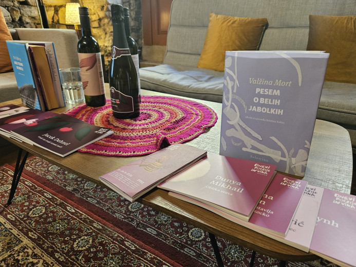 Books and bottles of wine displayed on a low table.