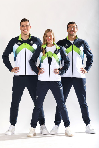Three athletes in tracksuit for the medal ceremony.