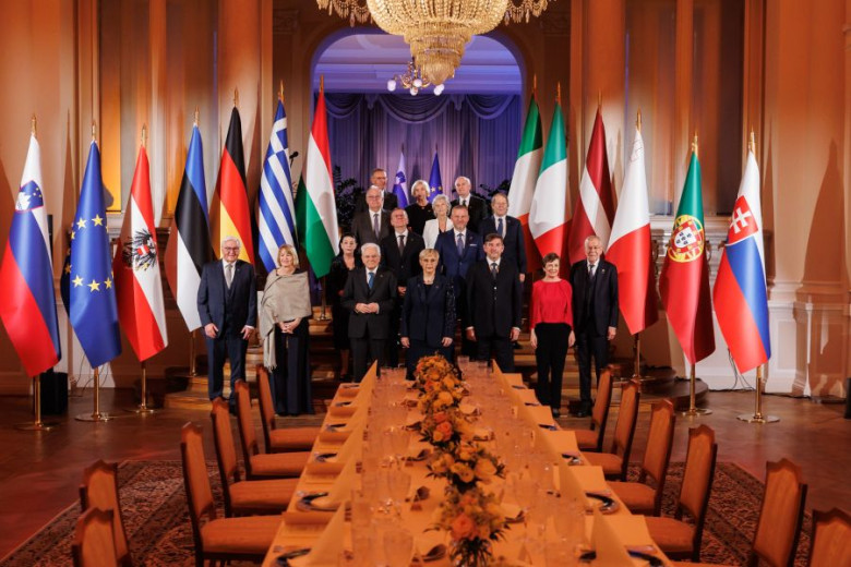 Twelve European presidents, members of the Arraiolos Group, pose for a formal summit photo between national flags.