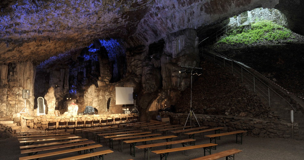 Benches and stage in the karst cave where the Vilenica festival takes place.