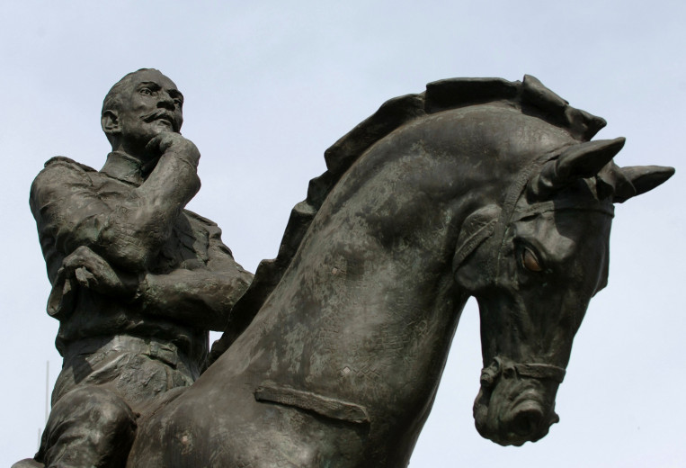 A statue of Maistre seated on horseback.