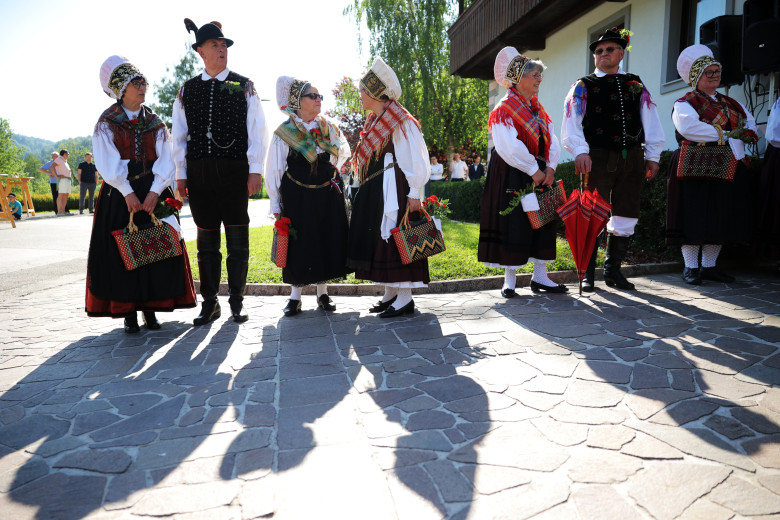 Performers in Gorenjska national costumes stand side by side.