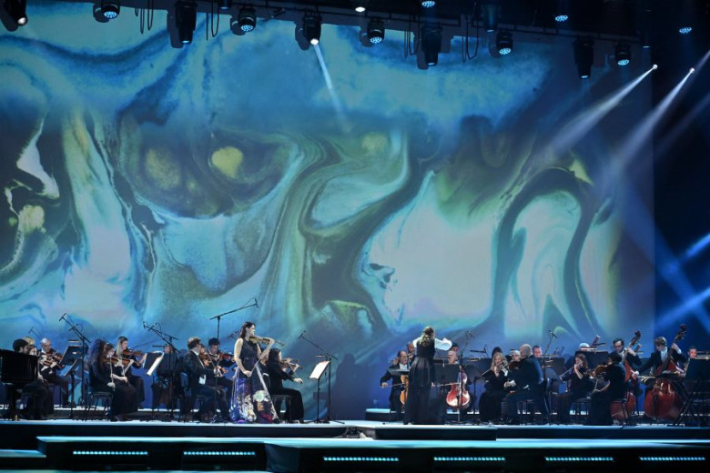 An orchestra playing on stage.