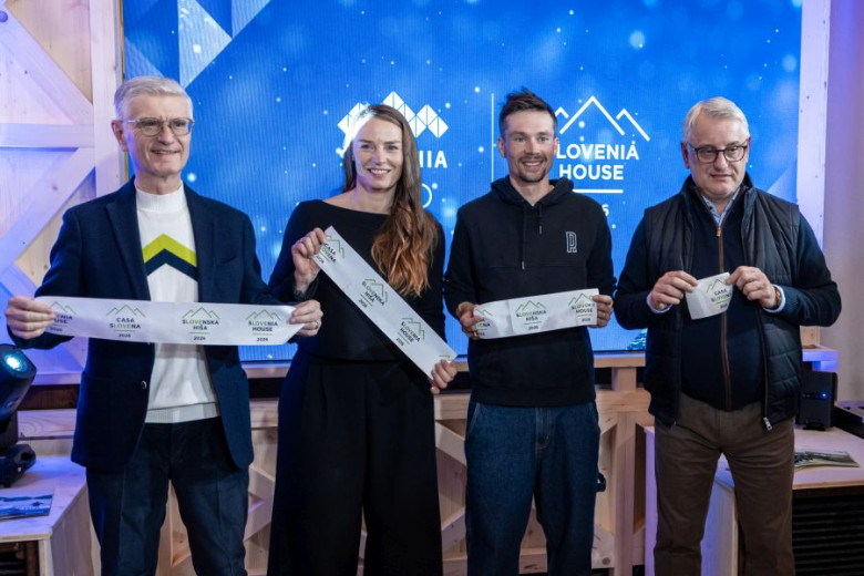 Franjo Bobinac, Tina Maze, Primož Roglič and Matjaž Han holding Slovenia house banners.