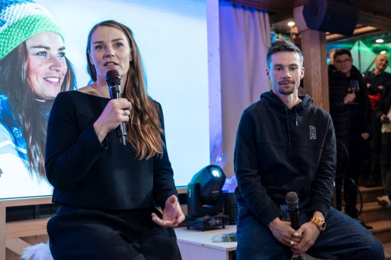 Tina Maze speaking on stage, next to her is Primož Roglič.