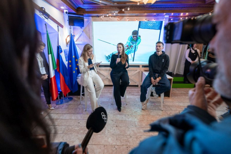 Tina Maze and Primož Roglič on stage during a round table discussion.